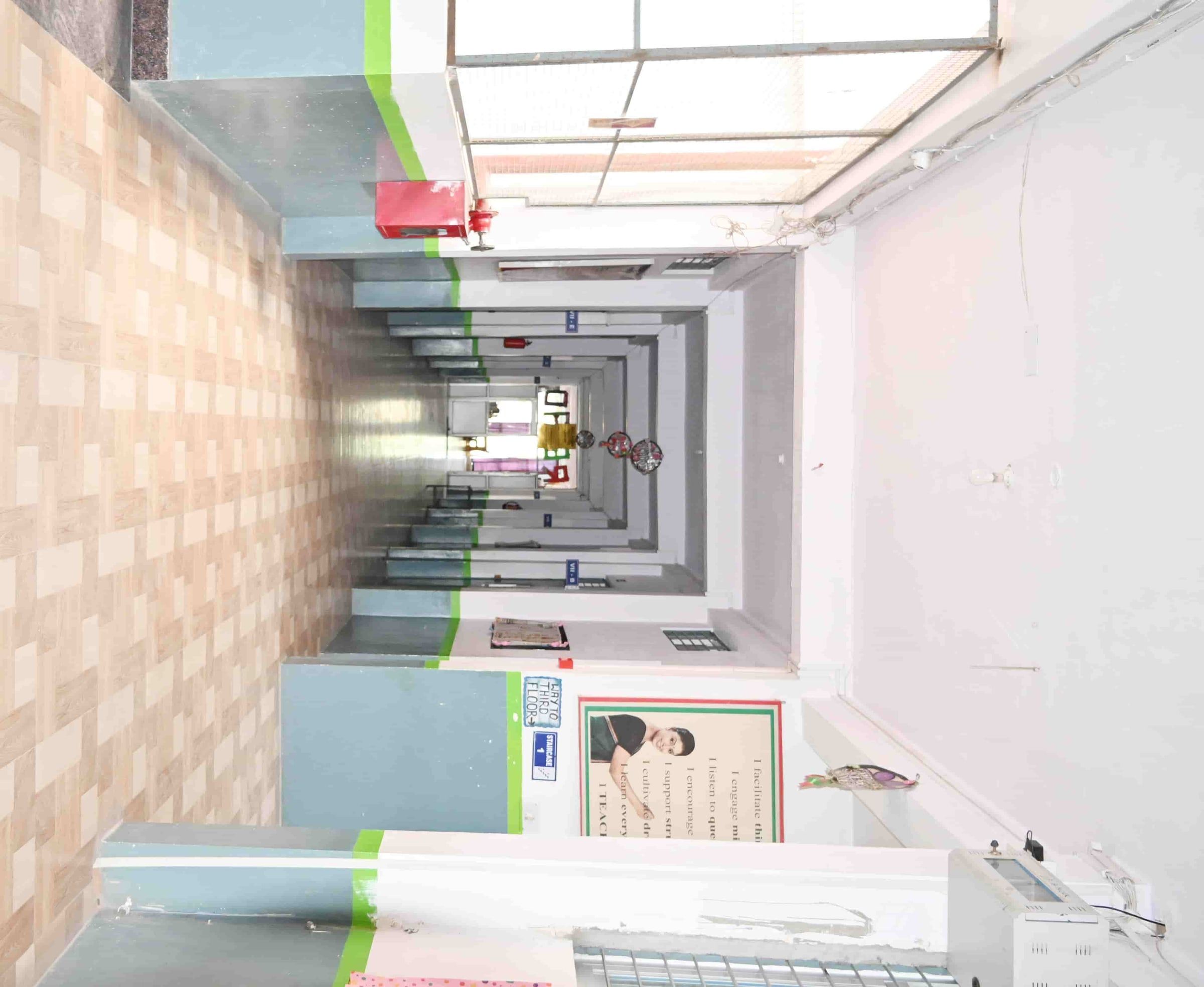 A corridor at Sunbeam School Ballia, its classroom doors running the length of the block.